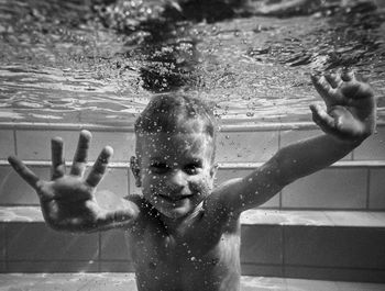 Portrait of shirtless boy swimming in water