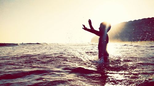 Silhouette of people enjoying at beach