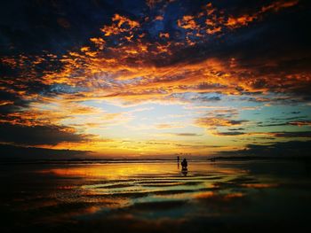 Scenic view of beach against sky during sunset