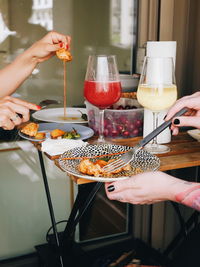 Midsection of woman having food in restaurant