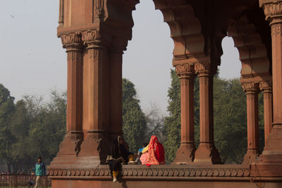 Rear view of people at historical building