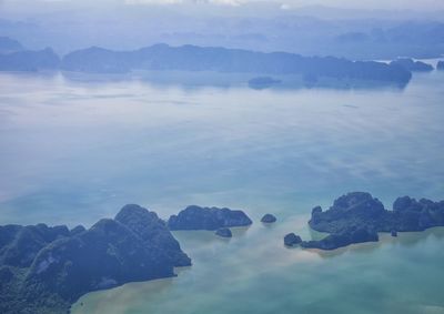 Scenic view of sea and mountains against sky