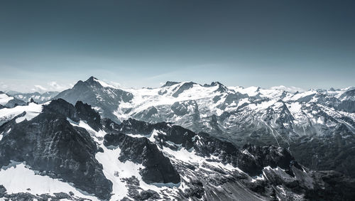 Scenic view of snowcapped mountains against clear sky