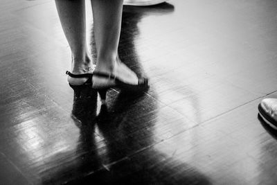 Low section of woman standing on tiled floor