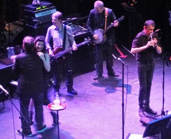 Group of people playing on stage at night