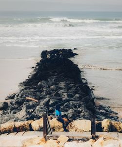 Scenic view of rocks on beach against sky