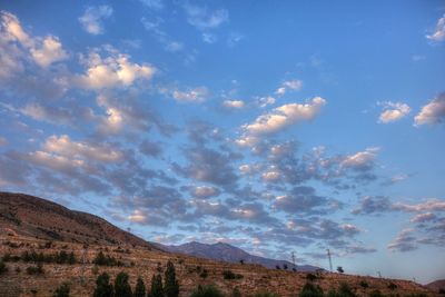 Scenic view of mountains against cloudy sky