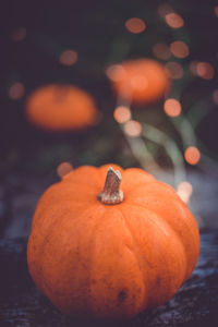 Isolated little pumpkins on a wooden table with beautiful blurred colorful background