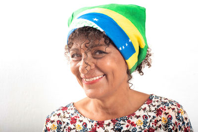 Portrait of mature, smiling brazilian woman wearing a bandana with the national flag