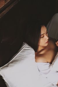 High angle view of woman sleeping on bed