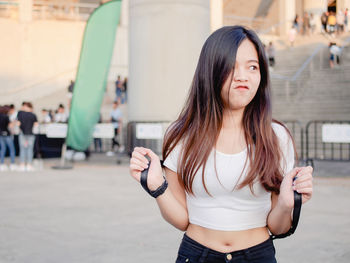 Portrait of happy asian young woman outdoors