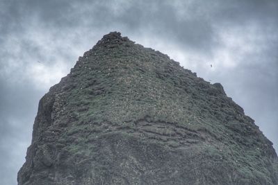 Low angle view of rock formation against sky