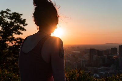 Rear view of woman looking at sunset