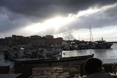 View of harbor against cloudy sky