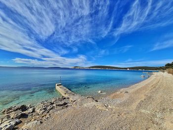 Scenic view of beach against blue sky