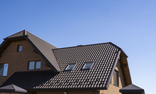 Low angle view of building against clear blue sky