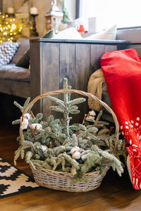 Christmas branches of fir or spruce in a composition with cotton in a wicker basket used as a decor