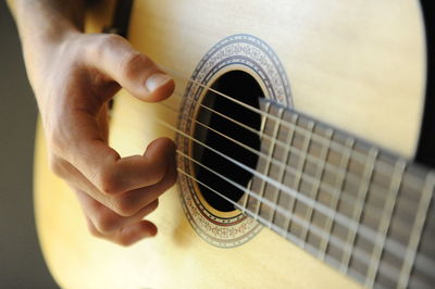 Close-up of hands playing guitar