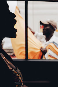 Close-up portrait of boy holding window