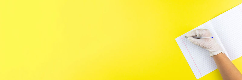 High angle view of yellow paper against wall
