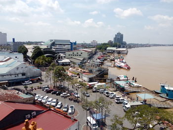 High angle view of buildings by sea against sky