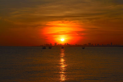 Scenic view of sea against orange sky