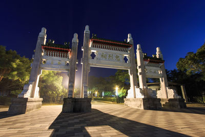 Low angle view of monument structure against blue sky