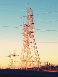 Low angle view of electricity pylon against sky