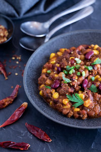 A bowl of black bean and corn chili con carne, ready for eating.