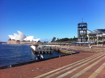 View of buildings against clear blue sky