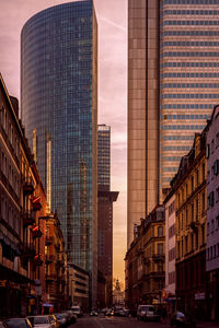 City buildings against sky during sunset