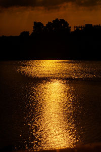 Scenic view of lake against orange sky