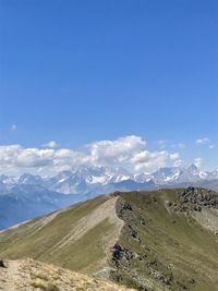 Scenic view of snowcapped mountains against blue sky