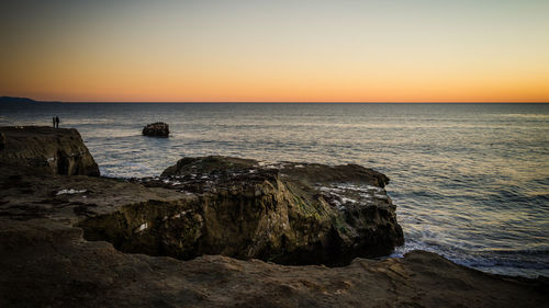 Scenic view of sea against clear sky during sunset