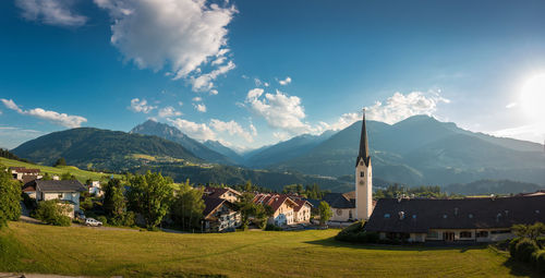 Panoramic view of trees and buildings against sky