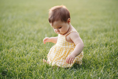 Cute boy looking away on field