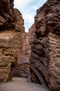 Low angle view of rock formation on land against sky