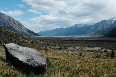 Scenic view of mountains against cloudy sky