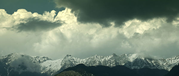 Panoramic view of snowcapped mountains against sky