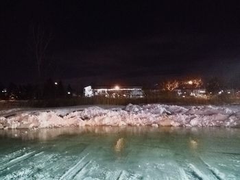 Scenic view of frozen lake against sky at night