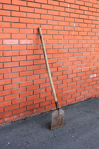 Footpath against brick wall