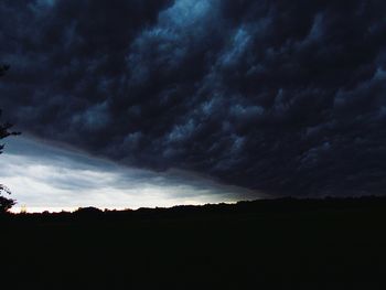 Silhouette of landscape against cloudy sky