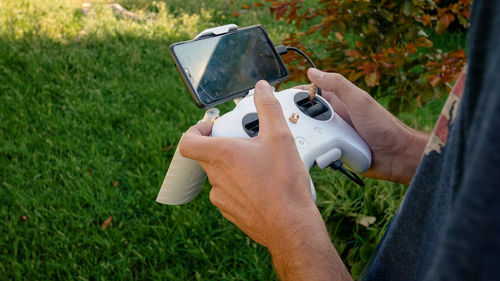 High angle view of man photographing camera on field