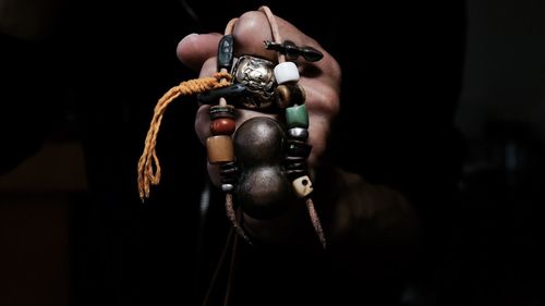 Cropped hand of man holding necklace