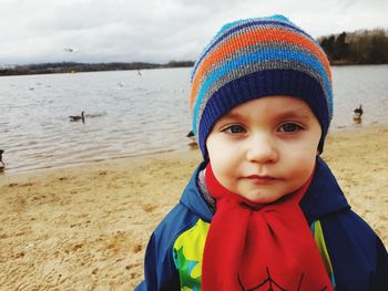 Portrait of boy standing on sand at beach