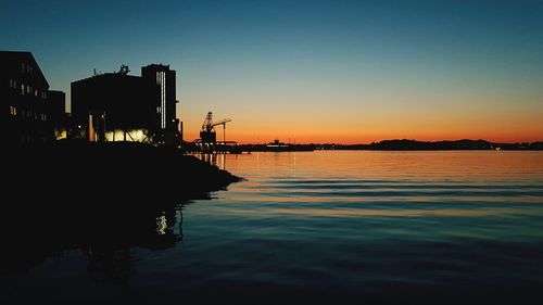 Silhouette boat in sea against sky during sunset