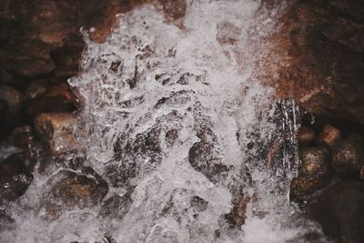 Close-up of water flowing through rocks