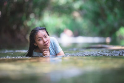 Portrait of a woman lying down outdoors