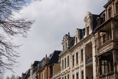 Low angle view of building against cloudy sky