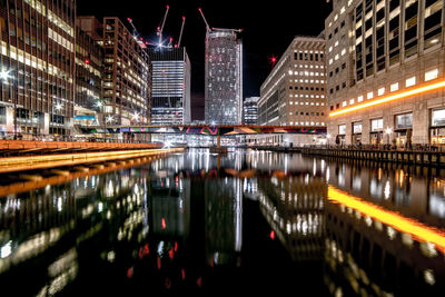 Reflection of illuminated buildings in river at night